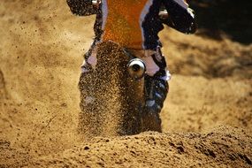 Athlete rides a motorcycle on the sand