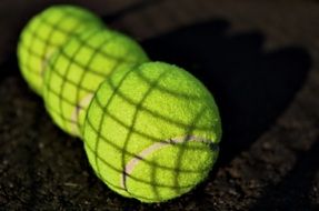 three green tennis balls close up