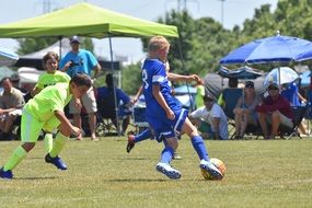 children's soccer match on a sunny day