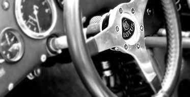 black and white photo steering wheel on a panel in a racing car