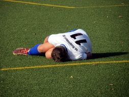 fallen football player on a field