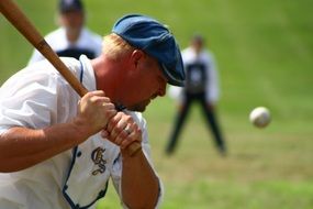 man hitting the ball with a bat in baseball