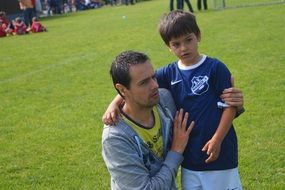 father supports son playing football