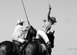 black and white photo of polo players on horseback