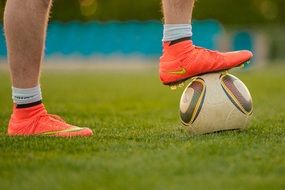 orange Nike Soccer Shoes on footballerâs feet