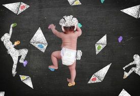 baby in diaper is climbing the wall
