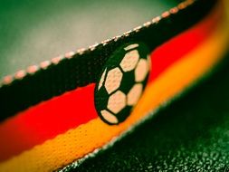 closeup picture of ball on the flag of germany at the bright football championship