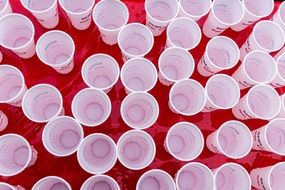 A lot of the plastic cups with water