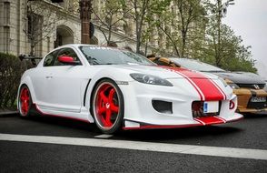 White sports car with a red stripe