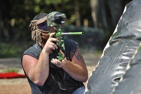 Man playing paintball on a sunny day