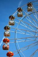 Ferris Wheel against the blue sky on a sunny day