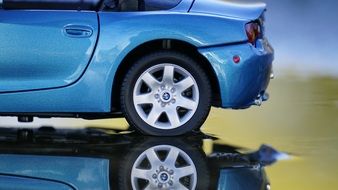 mirror reflection of a blue shiny car