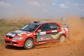 Sports car speeding on red sand, India