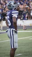 american football player of Kansas State University stands on a field, usa, Manhattan