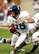 player in a black helmet with a ball in american football