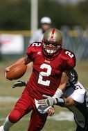 american football player in red uniform number 2