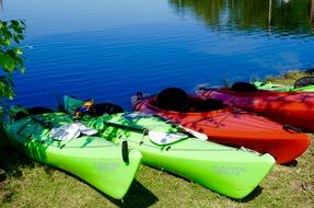 multi-colored kayaks on the shore