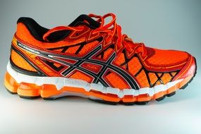 orange sneaker with bright laces for a run
