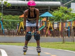 black girl is rollerblading in the park