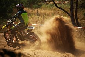 motorcyclist raises sand