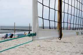 playing volleyball game on a sand beach