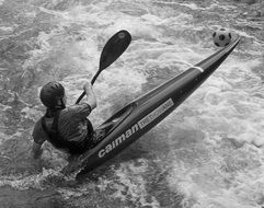 black and white photo of an athlete in a kayak