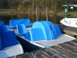 blue catamarans are parked on the pier