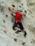 Climbing girl on a wall in amusement park