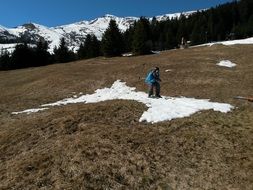 man stands in the snow on the field