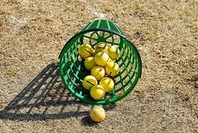 green basket with golf balls