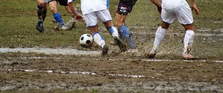 soccer game on muddy field