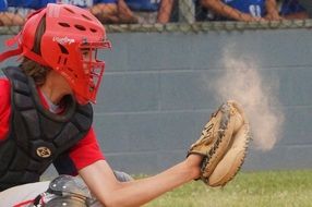 baseball player in red mask and glove