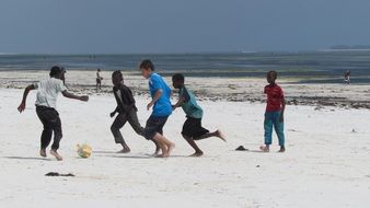 Africa Children play Football on the beach