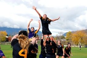 girls play rugby on the field