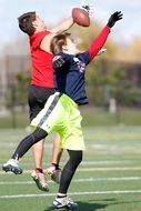 fighting for the ball in football on the field