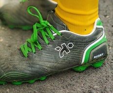 Rugby Shoes with green Laces on feet