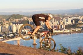 man doing bike trick on the beach