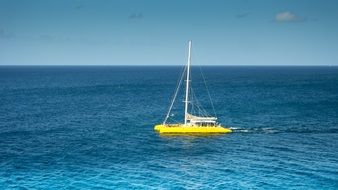 panoramic view of a yellow catamaran on the water