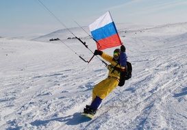 man skiing with russia flag in hands