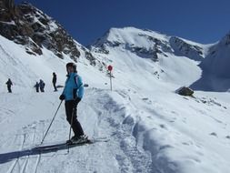 skiers on the track on a clear sunny day