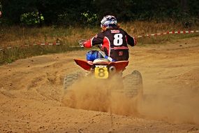 Man on the motocross on the sand