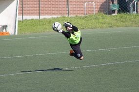 jump of a goalkeeper behind the ball