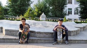 two young skateboarders on a city street