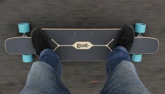 young man stands on a skateboard