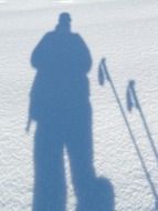 shadow of a man in the snow