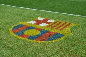 logo of the Barcelona football club on a green lawn