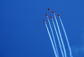 air show in bright blue sky