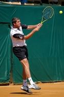 man hits the ball with a racket