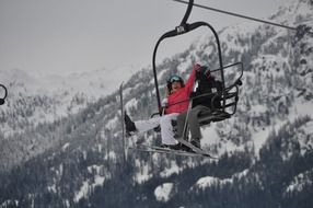 two athletes on a lift in the mountains in Canada