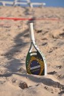 tennis racket on the sand